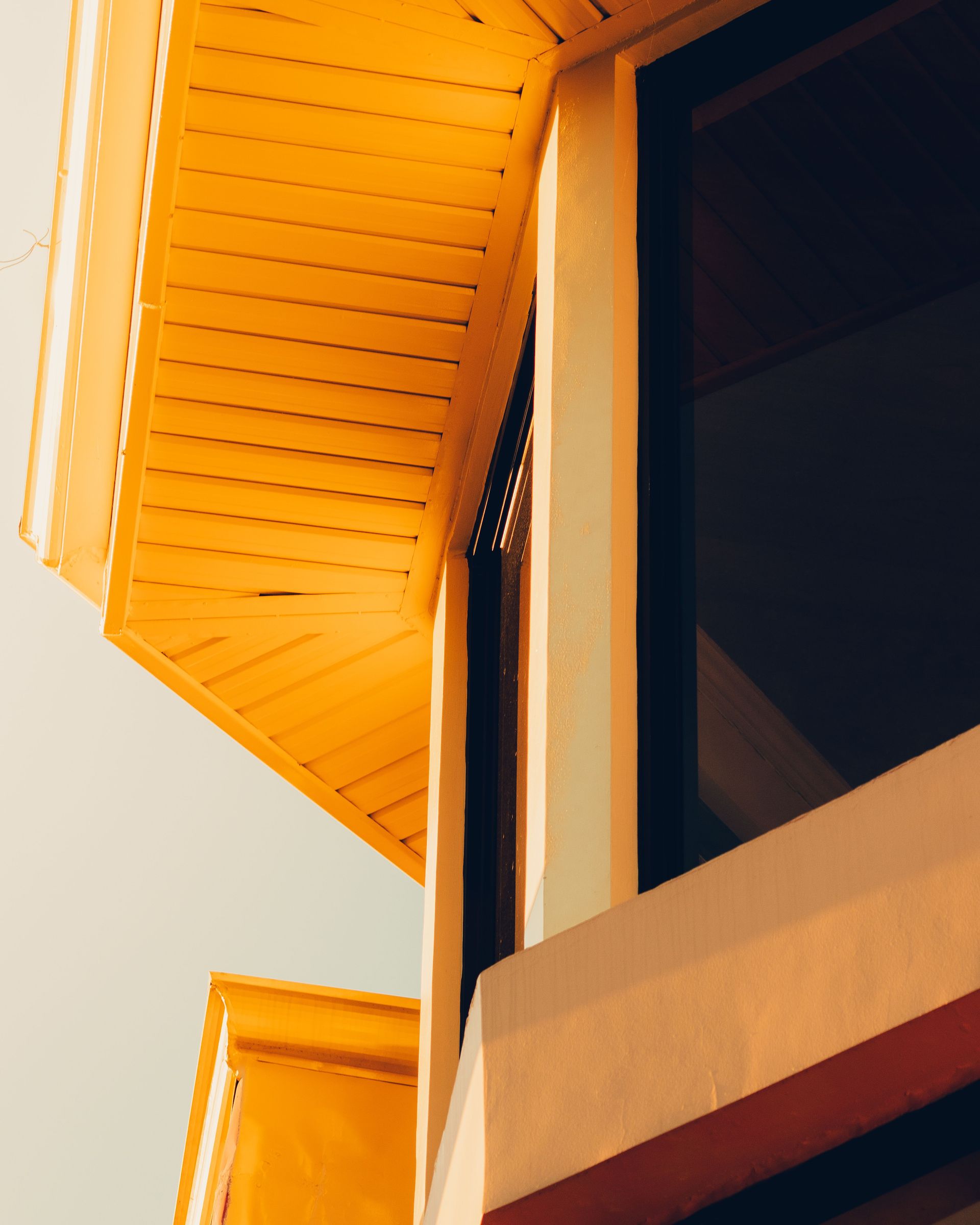 A closeup showcasing modern residential architecture with a focus on wooden elements and large windows.